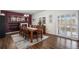 Elegant dining room with a large wooden table, seating for ten, and stylish decor creating a warm and inviting atmosphere at 3764 Balderas St, Brighton, CO 80601
