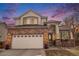 Charming two-story home featuring a brick facade, a two-car garage, and a well-maintained front yard under a beautiful sky at 3764 Balderas St, Brighton, CO 80601