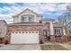 Charming two-story home featuring a brick facade, a two-car garage, and a well-maintained front yard under a beautiful sky at 3764 Balderas St, Brighton, CO 80601