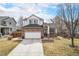 Charming two-story home featuring a brick facade, a two-car garage, and a well-maintained front yard on a sunny day at 3764 Balderas St, Brighton, CO 80601