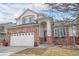 Charming two-story home featuring a brick facade, a two-car garage, and a well-maintained front yard on a sunny day at 3764 Balderas St, Brighton, CO 80601