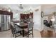 Spacious kitchen featuring stainless steel appliances, a kitchen island with seating, and an open layout to the living area at 3764 Balderas St, Brighton, CO 80601