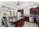 Open concept kitchen with stainless steel appliances, a large island with seating, and plenty of natural light from the windows at 3764 Balderas St, Brighton, CO 80601