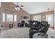 The bright living room is complete with vaulted ceilings, plantation shutters, and comfortable leather seating at 3764 Balderas St, Brighton, CO 80601