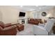 Cozy living room featuring a fireplace, plush seating, and a bright window at 3764 Balderas St, Brighton, CO 80601