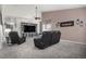 The cozy living room features plush carpet, a sleek fireplace, and comfortable seating for Gathering gatherings at 3764 Balderas St, Brighton, CO 80601