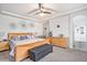 Serene main bedroom with a fan, carpet flooring, and a convenient ensuite bathroom for added privacy at 3764 Balderas St, Brighton, CO 80601