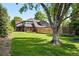 Expansive backyard featuring well-kept lawn, mature trees, and a fenced perimeter. A trampoline is also visible at 5441 S Dayton Ct, Greenwood Village, CO 80111