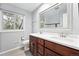 Bright bathroom with double vanity, a large window and a tub with subway tile surround at 5441 S Dayton Ct, Greenwood Village, CO 80111