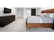 Stylish bedroom featuring a rustic wood bed frame, a black barn door, and neutral carpeting at 5441 S Dayton Ct, Greenwood Village, CO 80111