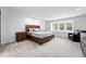 Bright bedroom with neutral colors, a large window, and a rustic wood bed frame at 5441 S Dayton Ct, Greenwood Village, CO 80111