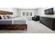 Bright bedroom with a rustic wooden bed frame, plush carpeting, and modern decor at 5441 S Dayton Ct, Greenwood Village, CO 80111