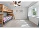Bedroom with bunk beds, natural light from a large window and neutral walls at 5441 S Dayton Ct, Greenwood Village, CO 80111