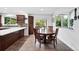 Eat-in dining area features a dark wood table with seating for four and sliding glass doors to the yard at 5441 S Dayton Ct, Greenwood Village, CO 80111