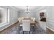 Formal dining room features decorative molding, elegant chandelier, and a large table for entertaining at 5441 S Dayton Ct, Greenwood Village, CO 80111