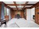 Wood-paneled home office with built-in bookshelves and coffered ceiling at 5441 S Dayton Ct, Greenwood Village, CO 80111
