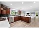 Open-concept kitchen with cherry wood cabinetry, stainless steel appliances, and an island at 5441 S Dayton Ct, Greenwood Village, CO 80111