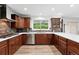 Modern kitchen with stainless appliances, granite countertops, wood cabinets and hardwood floors at 5441 S Dayton Ct, Greenwood Village, CO 80111