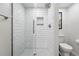 Modern shower features white subway tile, a glass door, chrome fixtures, and a mosaic tile shower floor at 5441 S Dayton Ct, Greenwood Village, CO 80111