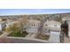 An aerial view showing home's setting in a suburban neighborhood with mountain views at 4526 Lyndenwood Pt, Highlands Ranch, CO 80130