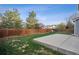 Spacious backyard featuring a concrete patio, lawn and tall wooden fence perfect for entertaining at 4526 Lyndenwood Pt, Highlands Ranch, CO 80130