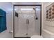 Modern bathroom boasts a tiled walk-in shower with a sleek, black frame and hardware at 4526 Lyndenwood Pt, Highlands Ranch, CO 80130