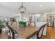 Dining area with stylish light fixture, hardwood floors and stairs that lead to upper floor at 4526 Lyndenwood Pt, Highlands Ranch, CO 80130