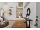 Inviting entryway that has hardwood floors and a view of the kitchen and the living room at 4526 Lyndenwood Pt, Highlands Ranch, CO 80130
