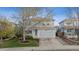 Charming two-story home with a well-manicured front yard and attached two-car garage at 4526 Lyndenwood Pt, Highlands Ranch, CO 80130
