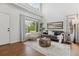 Bright living room featuring hardwood floors, neutral colors, and a cozy seating arrangement at 4526 Lyndenwood Pt, Highlands Ranch, CO 80130