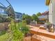 Backyard with a nice patio, lush greenery, and landscaped garden beds at 301 Harvest St, Longmont, CO 80501