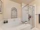 Bright bathroom featuring a soaking tub and glass-enclosed shower at 301 Harvest St, Longmont, CO 80501