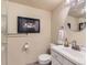 Bathroom featuring modern vanity, framed artwork, and a decorative vanity mirror at 301 Harvest St, Longmont, CO 80501