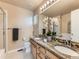 Bathroom with granite countertops and double sinks, complemented by a well-lit mirror at 301 Harvest St, Longmont, CO 80501