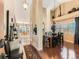 Elegant dining room with hardwood floors, a large chandelier, and an open view of the living area at 301 Harvest St, Longmont, CO 80501