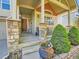 Close-up of the front entrance showcasing stone pillars, a wooden front door, and a decorative front porch at 301 Harvest St, Longmont, CO 80501