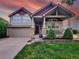 Charming home featuring a covered porch, well-manicured lawn, and two-car garage at 301 Harvest St, Longmont, CO 80501