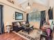 Cozy living room featuring a vaulted ceiling, large window, leather sofa, and stylish decor at 301 Harvest St, Longmont, CO 80501
