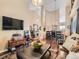 Open living space with a vaulted ceiling, hardwood floors, and seamlessly connecting the living and dining areas at 301 Harvest St, Longmont, CO 80501