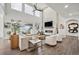 Inviting living room with high ceilings, a stone fireplace, and lots of natural light at 4848 Wagontrail Ct, Parker, CO 80134