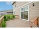 Charming back deck featuring lush greenery and a sliding door entrance for seamless indoor-outdoor living at 594 Fall River Ct, Brighton, CO 80601