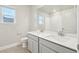 Well-lit bathroom with a double vanity, a large mirror, and a shower-tub combo at 594 Fall River Ct, Brighton, CO 80601