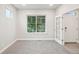 Comfortable carpeted bedroom with large window and a stylish french door at 594 Fall River Ct, Brighton, CO 80601