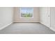 Inviting bedroom with a large window for natural light and soft carpeting for added comfort at 594 Fall River Ct, Brighton, CO 80601