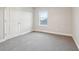 Cozy bedroom with soft carpeting, a window view, and a spacious closet door at 594 Fall River Ct, Brighton, CO 80601
