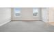 Bright Primary bedroom with two windows and door to the Primary bathroom at 594 Fall River Ct, Brighton, CO 80601