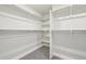 Walk-in closet with built-in shelving and hanging rods at 594 Fall River Ct, Brighton, CO 80601