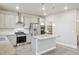 Bright kitchen features stainless appliances, granite counters, a center island and white subway tile backsplash at 594 Fall River Ct, Brighton, CO 80601