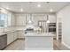Bright kitchen features stainless appliances, granite counters, a center island and white subway tile backsplash at 594 Fall River Ct, Brighton, CO 80601