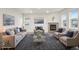 Bright and airy living room with neutral tones, fireplace, stylish furniture, and a decorative area rug at 594 Fall River Ct, Brighton, CO 80601